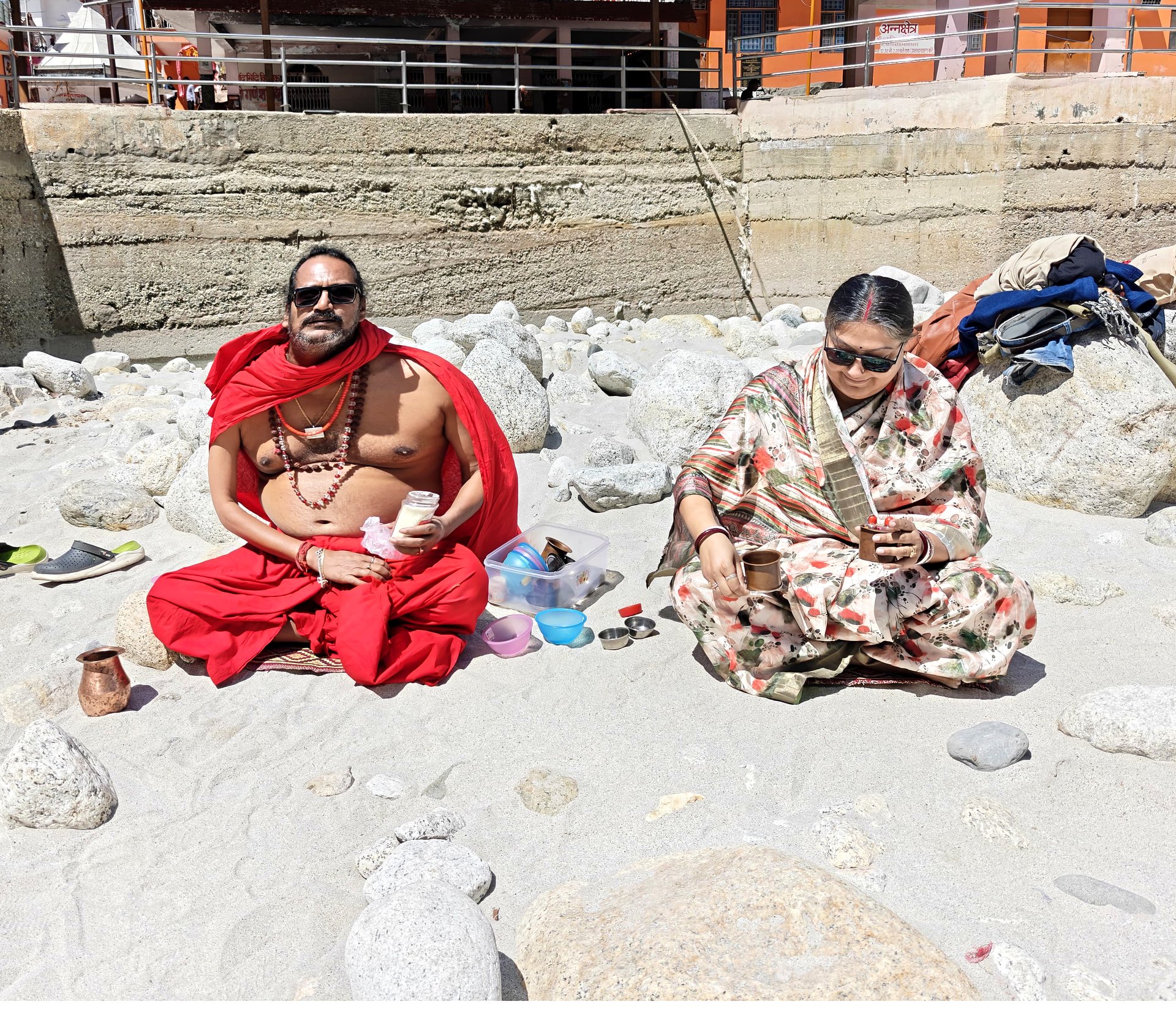 Sri Meenananda Tirthanath and Guruma Minakshi Devyomba seated together at a Himalayan river.